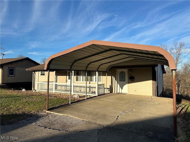 view of vehicle parking with a carport and a lawn