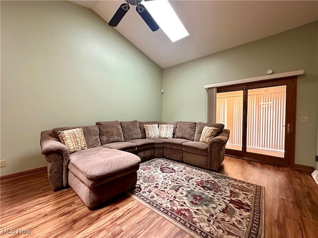 living room featuring ceiling fan, hardwood / wood-style floors, and lofted ceiling