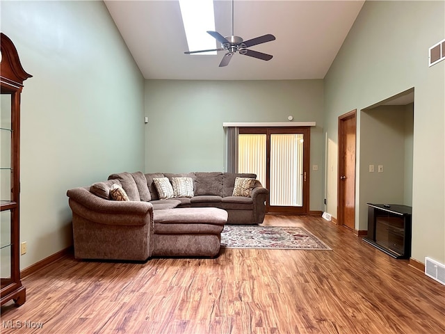 living room featuring hardwood / wood-style flooring and high vaulted ceiling