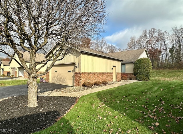 view of property exterior featuring a lawn and a garage