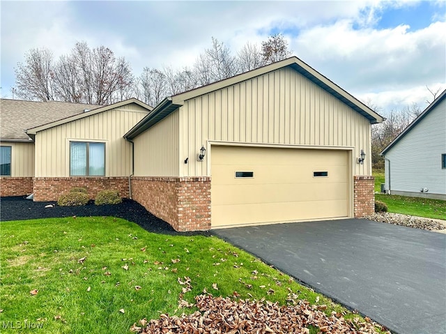 view of side of home featuring a yard and a garage