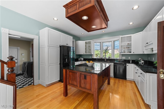 kitchen featuring black appliances, a kitchen island, white cabinetry, and light hardwood / wood-style flooring