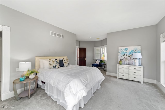 bedroom featuring light colored carpet