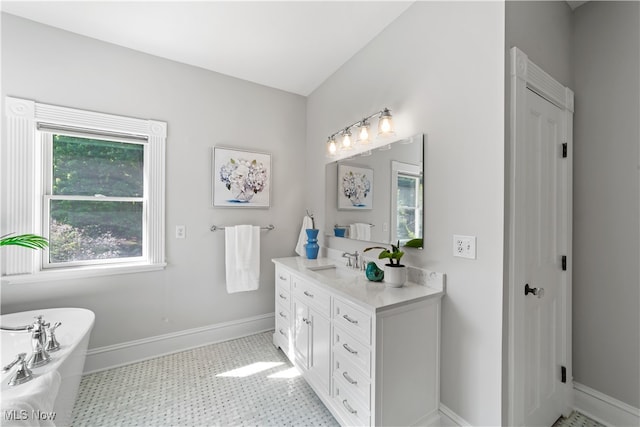 bathroom featuring vanity, a tub to relax in, and tile patterned floors