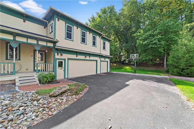 view of front of property with a porch and a garage