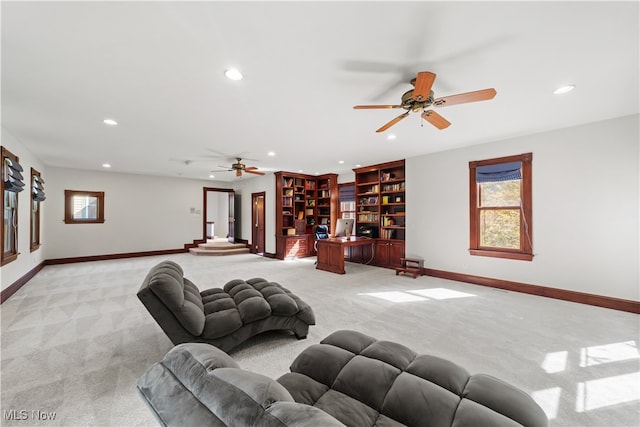 living room with ceiling fan and light colored carpet