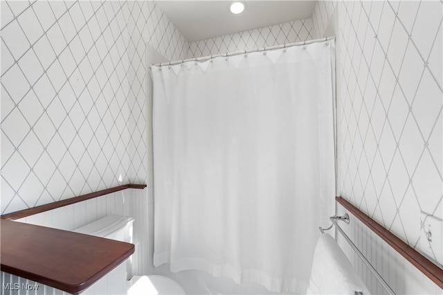 bathroom with tile walls