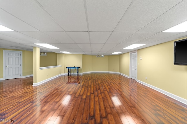 basement featuring a drop ceiling and wood-type flooring