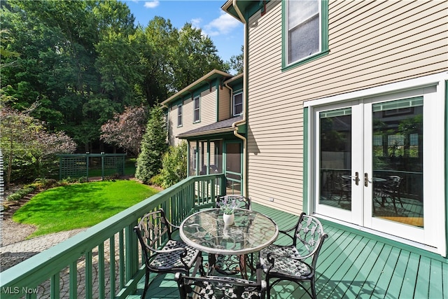 wooden balcony featuring french doors and a deck