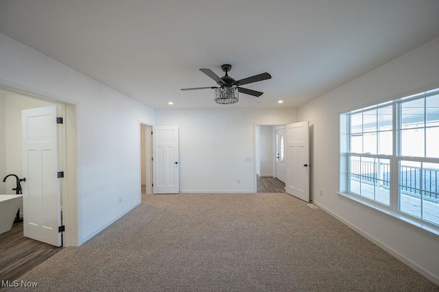 carpeted empty room with ceiling fan