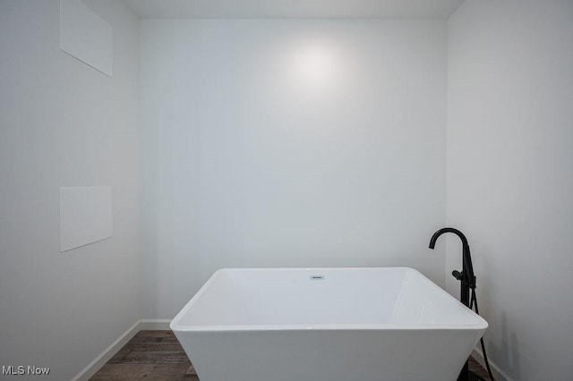 bathroom featuring hardwood / wood-style floors, sink, and a bath