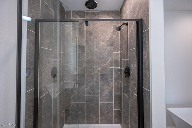 bathroom with a shower with shower door