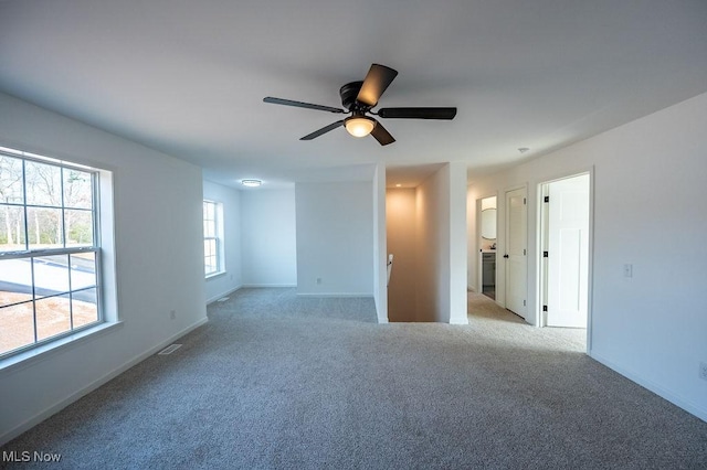 empty room with light colored carpet and ceiling fan