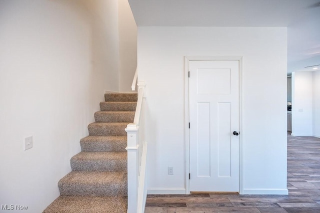 staircase featuring hardwood / wood-style floors