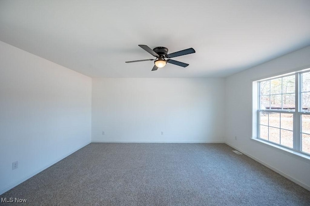 spare room featuring carpet flooring and ceiling fan