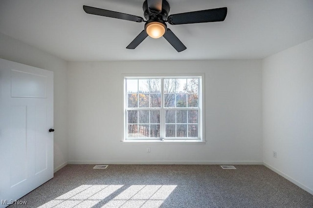 empty room with ceiling fan and light colored carpet