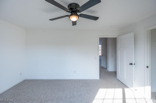 unfurnished room featuring light carpet and ceiling fan