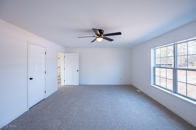 spare room with carpet flooring and ceiling fan