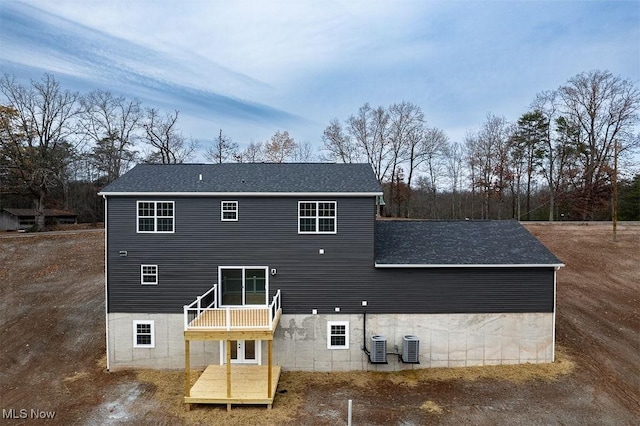 back of property featuring a deck and central AC