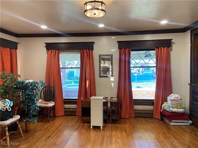 interior space featuring wood-type flooring and ornamental molding