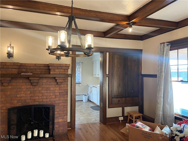 interior space with beam ceiling, wood-type flooring, a wealth of natural light, and a brick fireplace