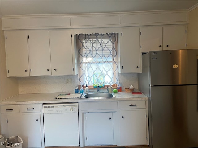 kitchen featuring white cabinets, stainless steel fridge, sink, and white dishwasher