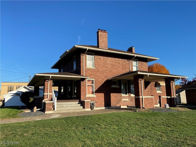 back of property featuring a lawn and covered porch