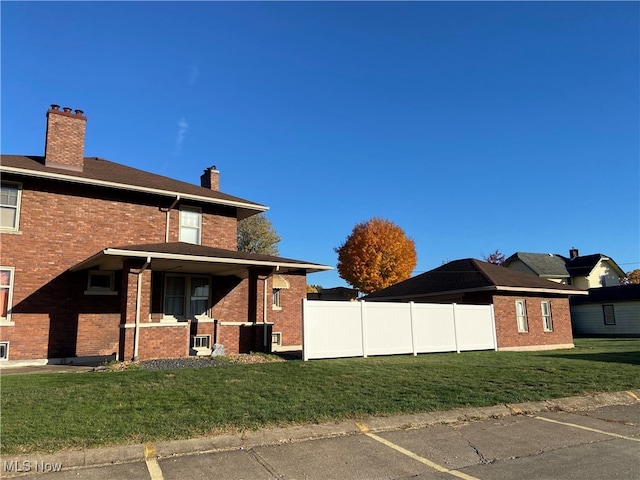 view of property exterior featuring a lawn