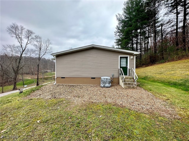 view of side of home with a lawn