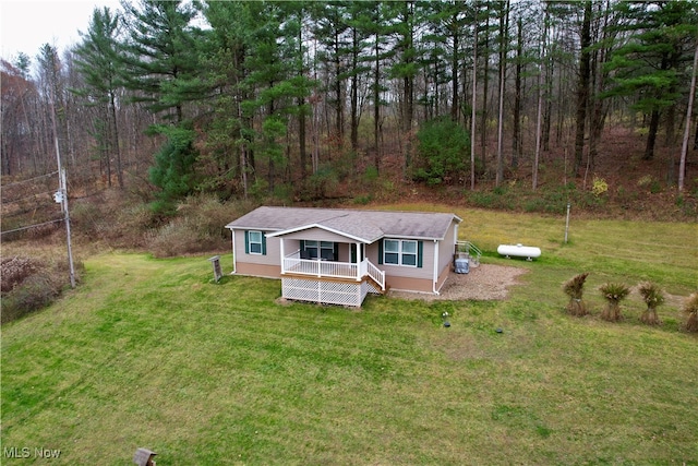 view of front of home featuring covered porch and a front lawn