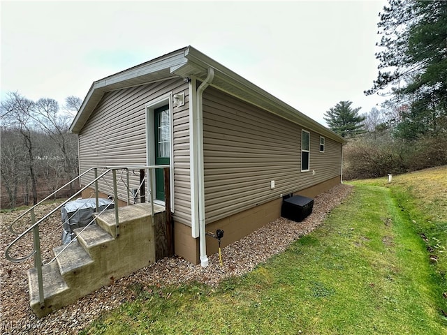 view of side of home featuring a lawn