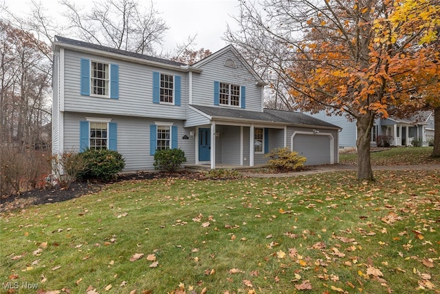 view of front facade featuring a front lawn, a porch, and a garage