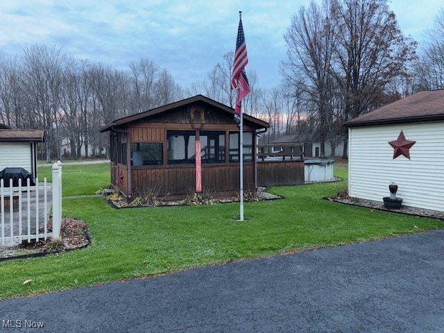 yard at dusk with a sunroom