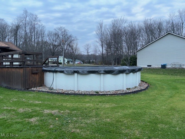 view of pool featuring a yard