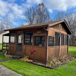 view of outdoor structure with a yard