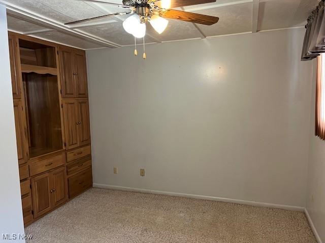 empty room with light carpet and ceiling fan