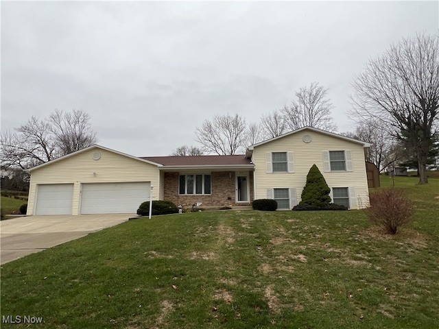 split level home featuring a garage and a front lawn