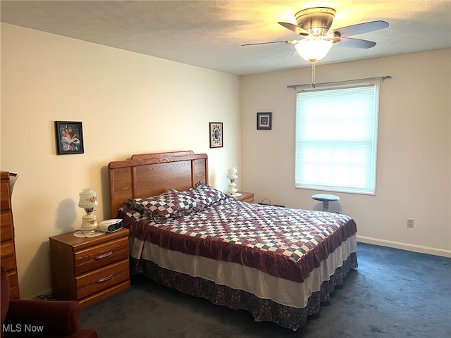 carpeted bedroom with ceiling fan and a textured ceiling