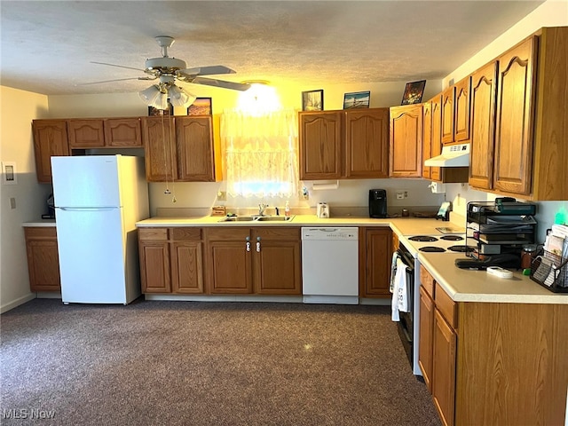 kitchen with ceiling fan, sink, dark colored carpet, a textured ceiling, and white appliances