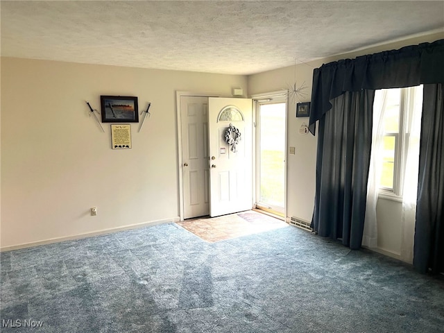 entrance foyer with carpet and a textured ceiling