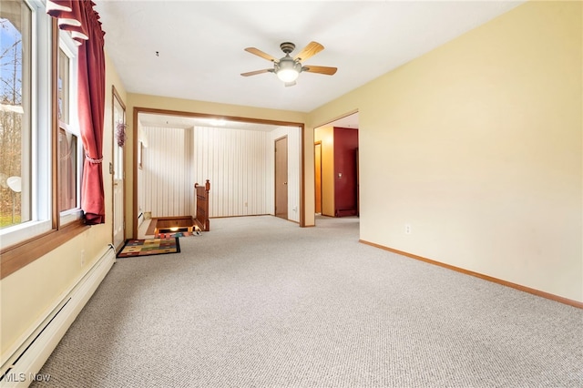 empty room featuring ceiling fan, light colored carpet, and a baseboard radiator