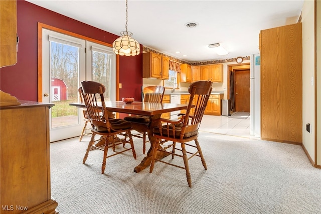 carpeted dining space with sink