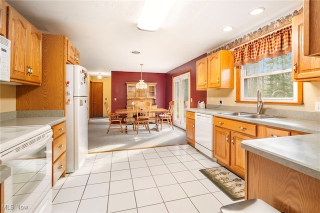 kitchen with light carpet, sink, hanging light fixtures, and white appliances