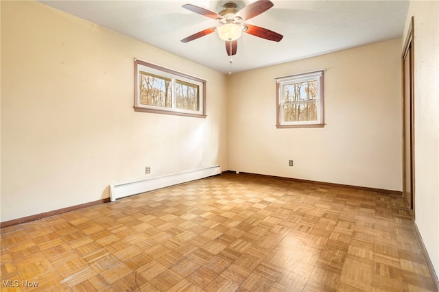 unfurnished room with ceiling fan, light parquet floors, and a baseboard heating unit