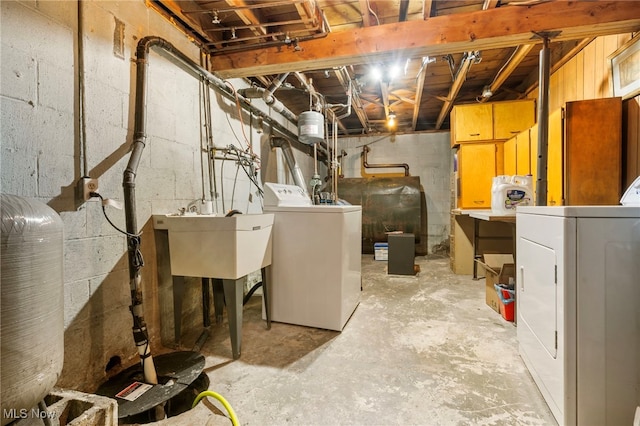 basement with washer and clothes dryer and sink