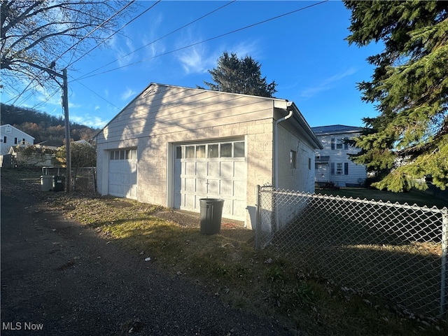 view of home's exterior featuring an outbuilding and a garage