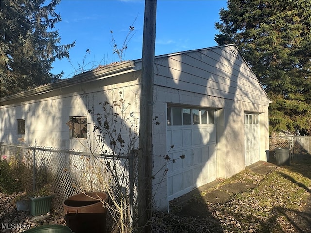 view of home's exterior with an outdoor structure and a garage