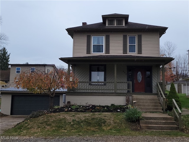 front of property with covered porch and a garage