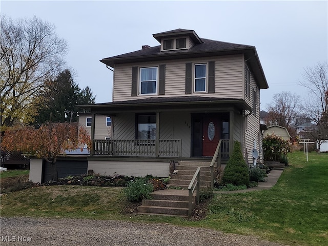 front facade featuring a porch and a front lawn