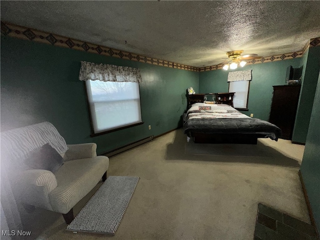 bedroom featuring a textured ceiling, ceiling fan, baseboard heating, and carpet